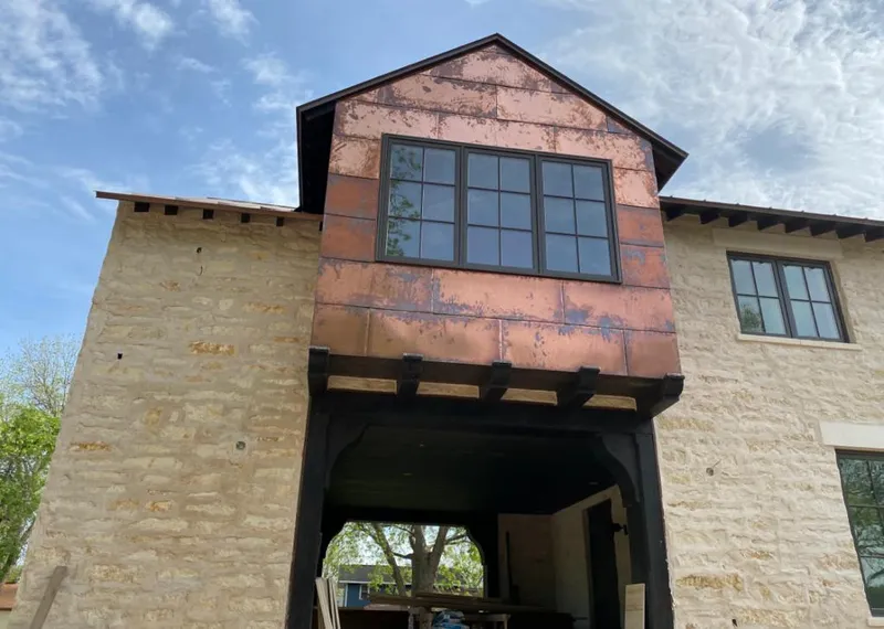 Copper metal panel facade on a stone building for Skylight Installation in St. Matthews